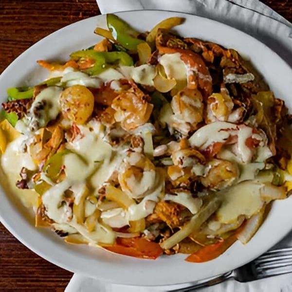 Los Mayas Mexican fajita nachos with shrimp, chicken, steak, bell peppers, onions, and melted cheese.