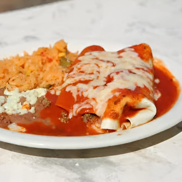 Los Mayas' enchiladas with red sauce and melted cheese, served with rice and refried beans.